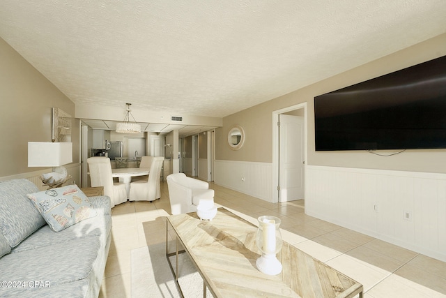 tiled living room featuring a textured ceiling