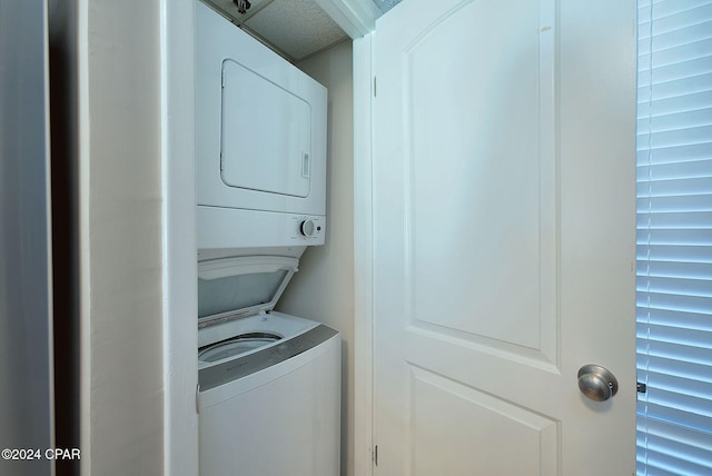 laundry area with stacked washer and clothes dryer