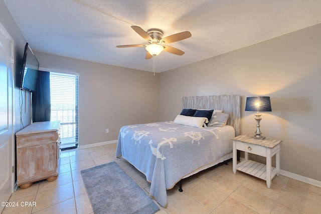 tiled bedroom with a textured ceiling and ceiling fan