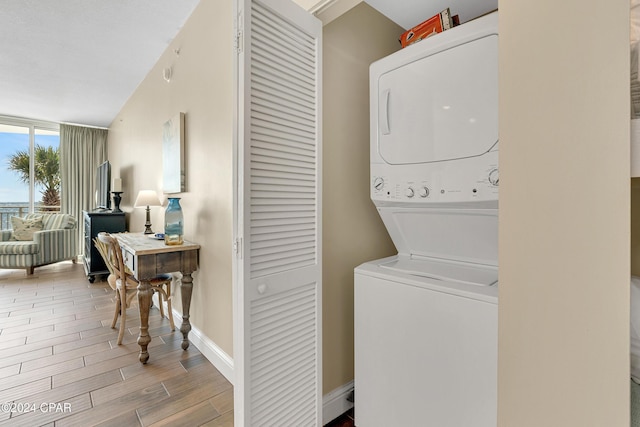 laundry room with stacked washing maching and dryer