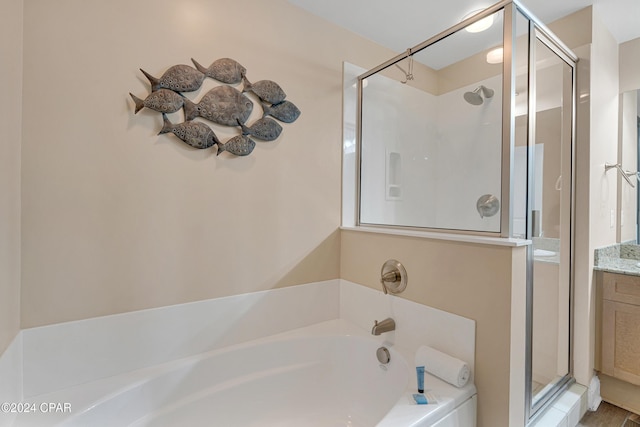 bathroom with vanity and independent shower and bath