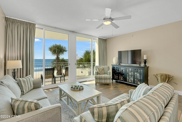 15625 Front Beach Rd Unit 205, Panama City Beach, FL 32413 - living area with expansive windows, wood finished floors, and ceiling fan