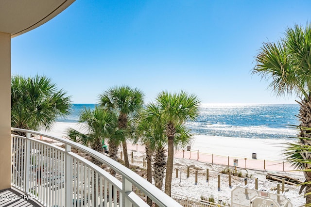 balcony featuring a beach view and a water view