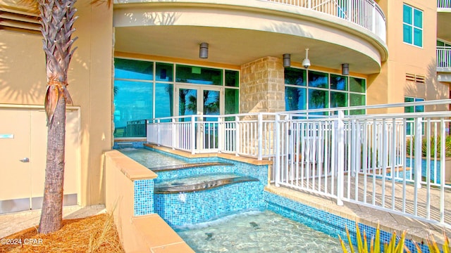 view of pool with a jacuzzi