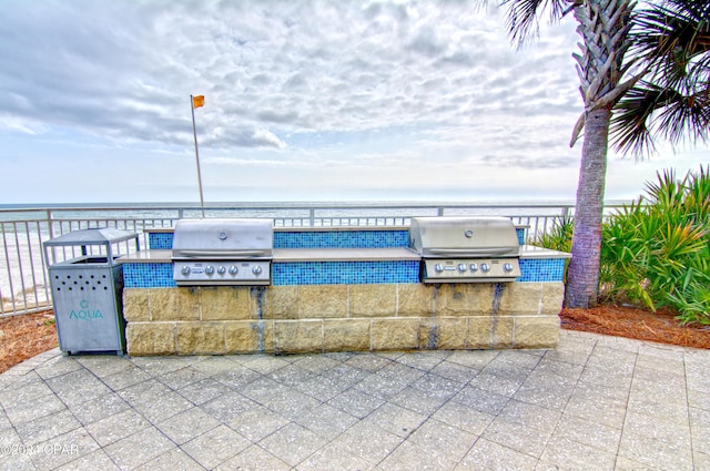 15625 Front Beach Rd Unit 205, Panama City Beach, FL 32413 - view of patio with an outdoor kitchen and a water view