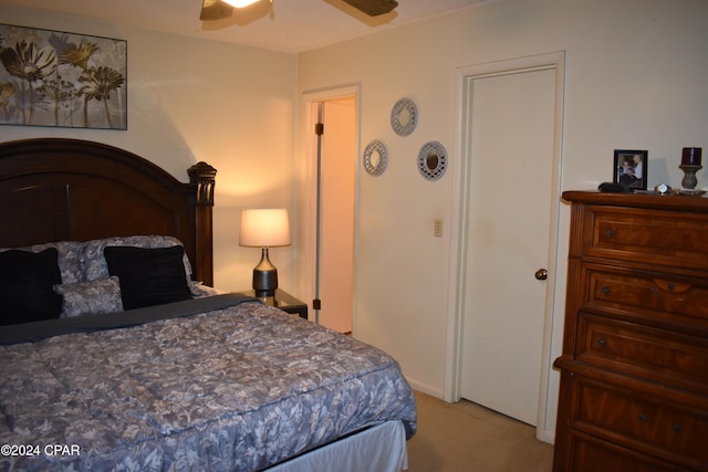 bedroom featuring light colored carpet and ceiling fan