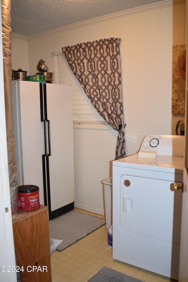 laundry room featuring washer / dryer and a textured ceiling