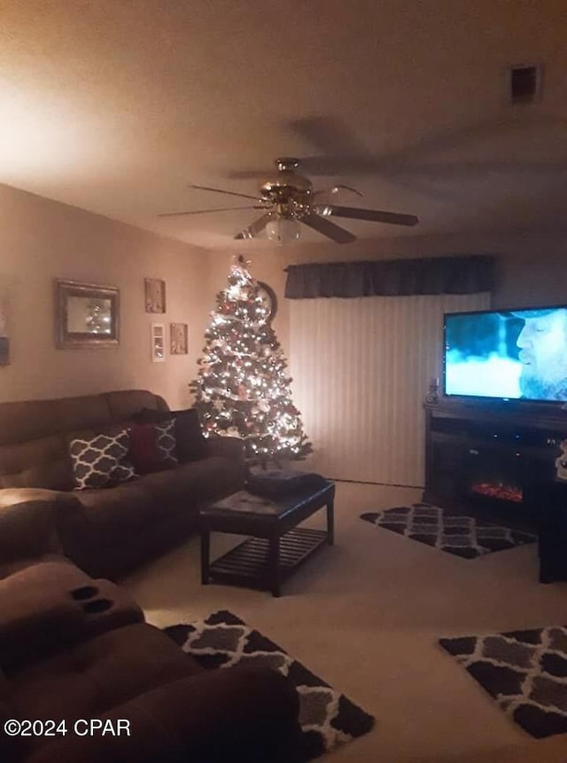 living room featuring carpet floors and ceiling fan