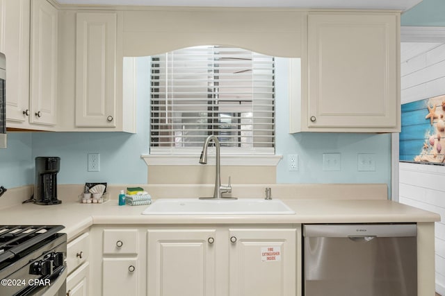 kitchen featuring white cabinetry, sink, and stainless steel dishwasher