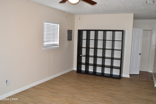 spare room featuring hardwood / wood-style flooring, a textured ceiling, and ceiling fan