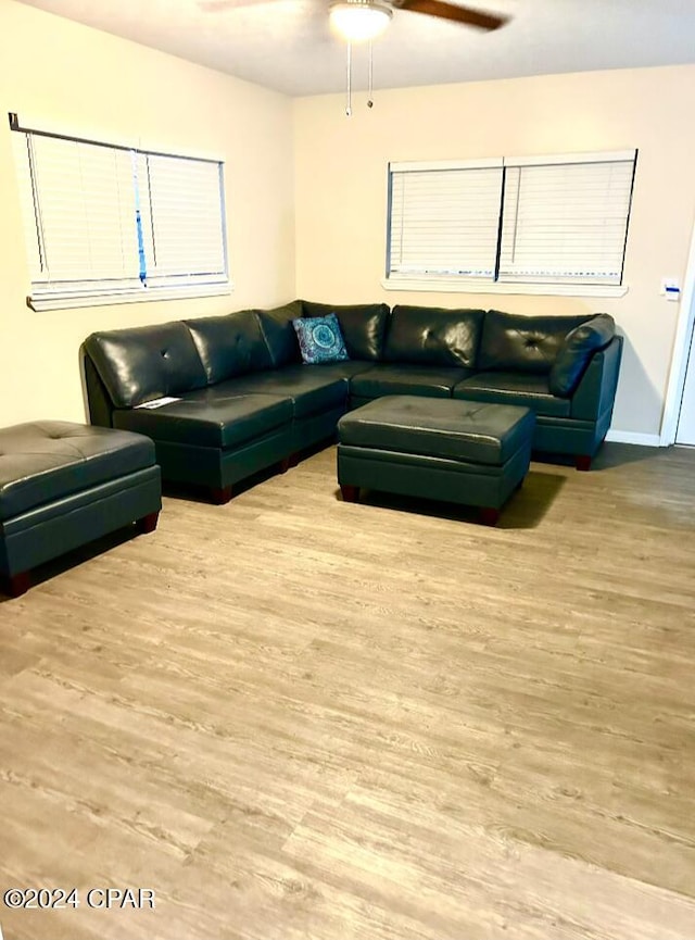 living room with ceiling fan and light wood-type flooring