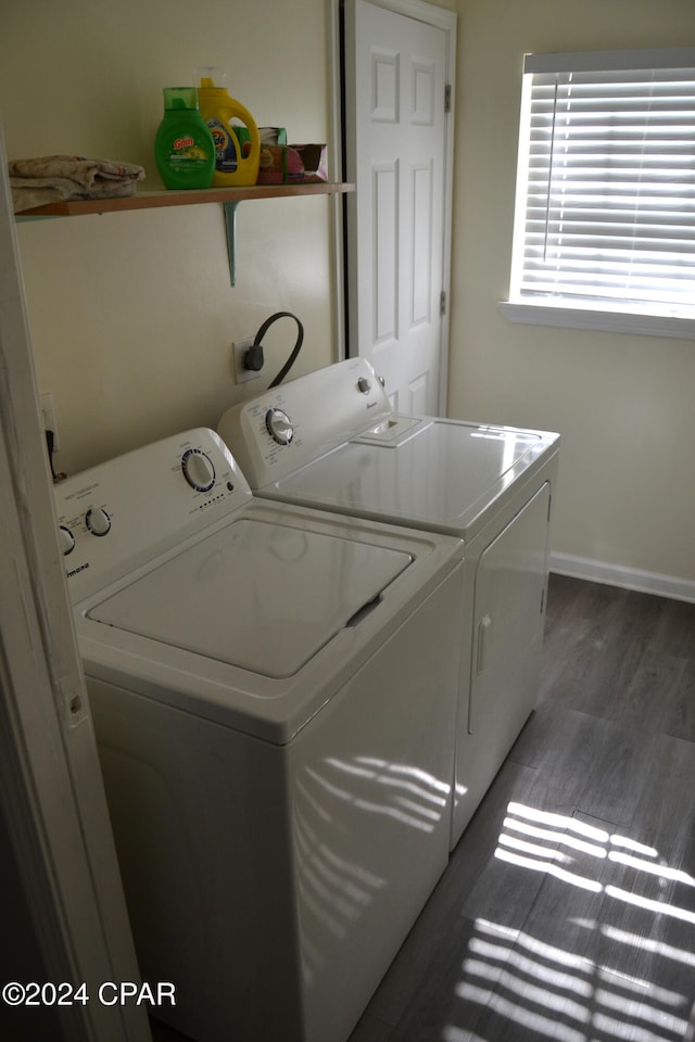 laundry room with dark wood-type flooring and washer and clothes dryer