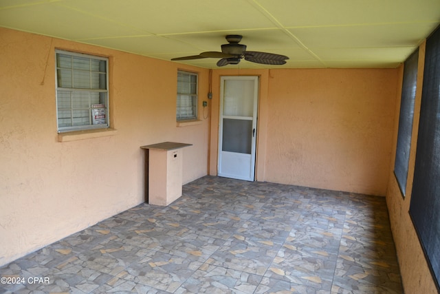 exterior space with ceiling fan