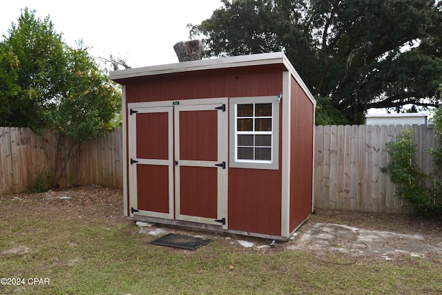 view of outdoor structure featuring a lawn