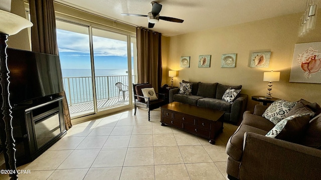 tiled living room with ceiling fan