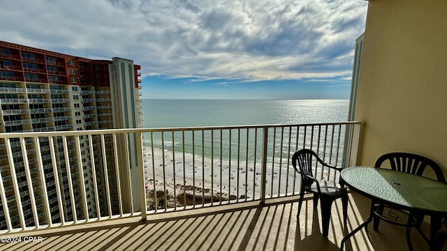 balcony featuring a water view and a view of the beach