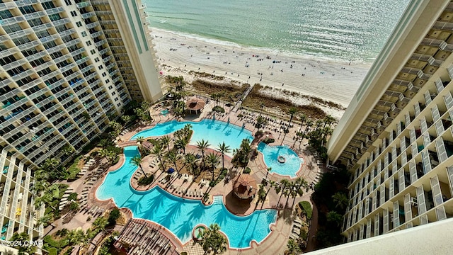 bird's eye view featuring a water view and a beach view