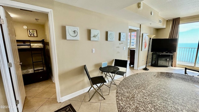 living room featuring a fireplace, plenty of natural light, and light tile patterned floors