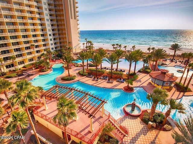 view of pool with a water view and a view of the beach