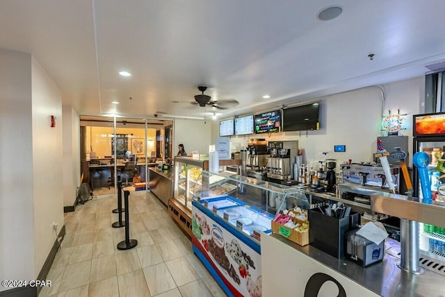 rec room featuring light tile patterned floors and ceiling fan