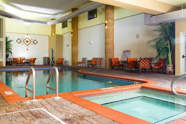 view of swimming pool with an indoor in ground hot tub