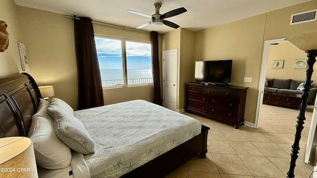 bedroom with ceiling fan and light tile patterned flooring