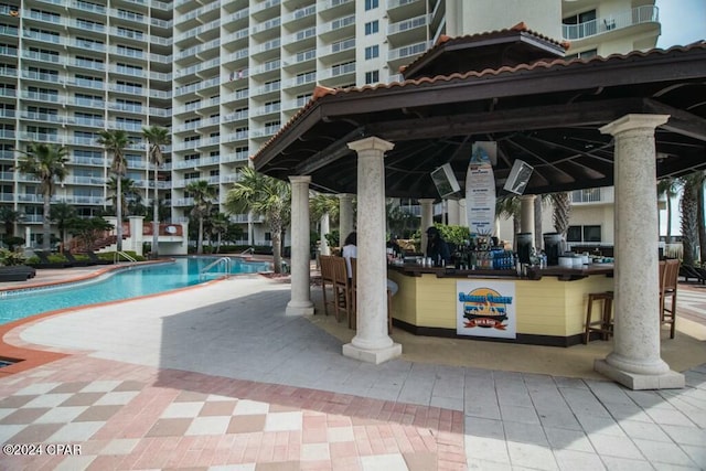 view of swimming pool featuring a gazebo and a bar