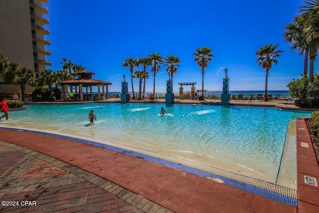 view of pool with a gazebo and pool water feature