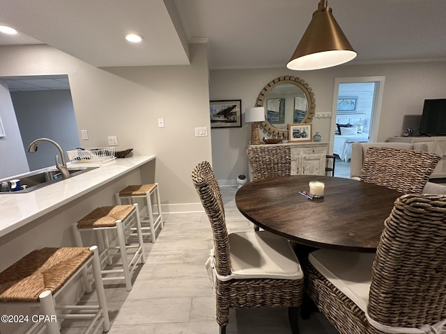 dining room with crown molding and sink