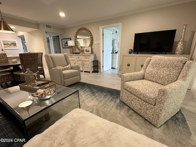 living room with ornamental molding and hardwood / wood-style floors