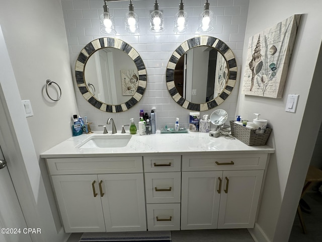 bathroom featuring vanity and decorative backsplash