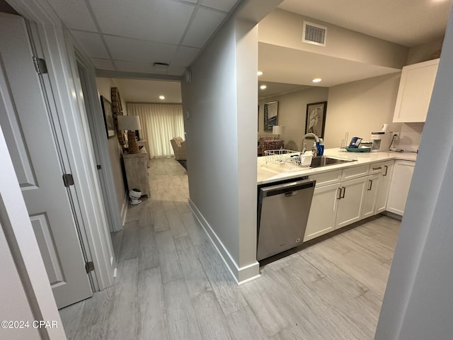 hall with light wood-type flooring, a drop ceiling, and sink