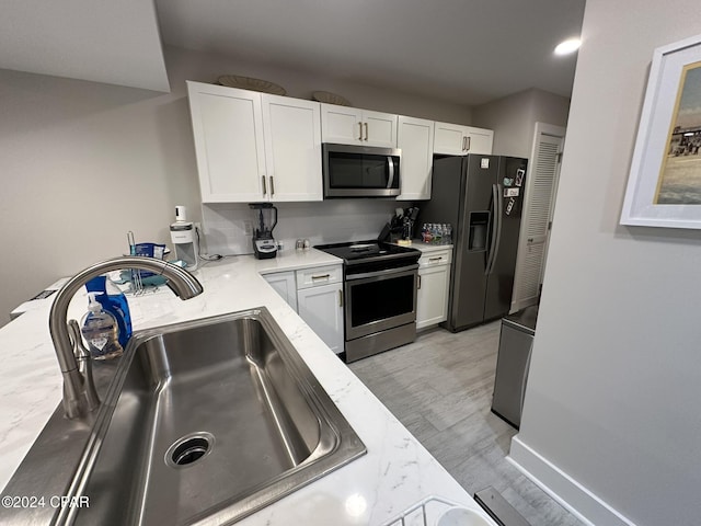 kitchen featuring white cabinets, appliances with stainless steel finishes, and sink