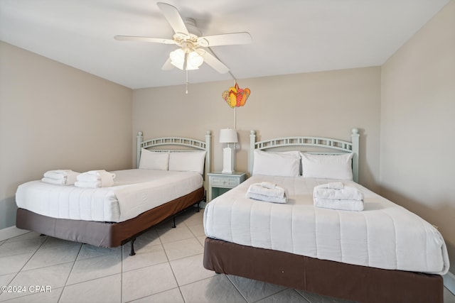 bedroom featuring light tile patterned floors and ceiling fan