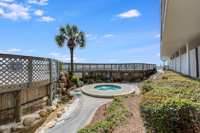 view of pool featuring an in ground hot tub