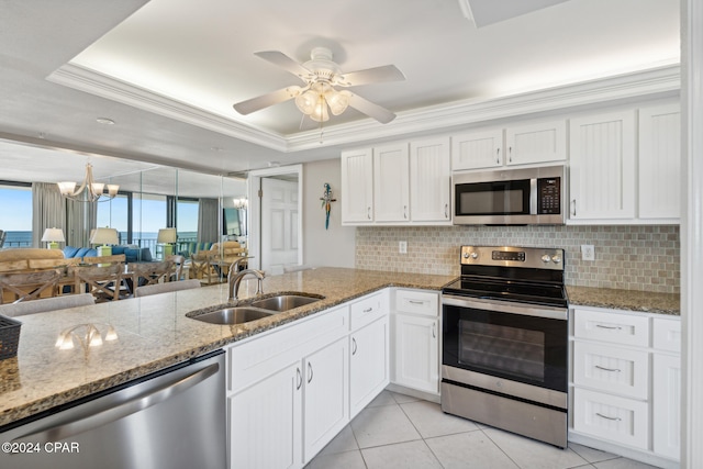 kitchen featuring white cabinets, a raised ceiling, sink, light tile patterned floors, and appliances with stainless steel finishes