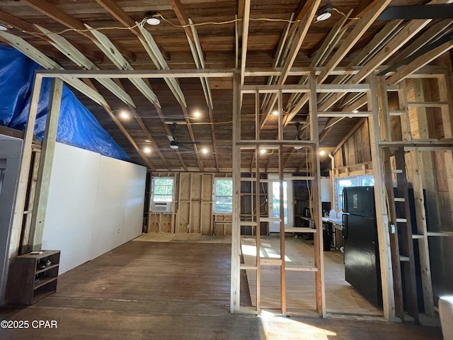 miscellaneous room featuring cooling unit, lofted ceiling, and hardwood / wood-style flooring