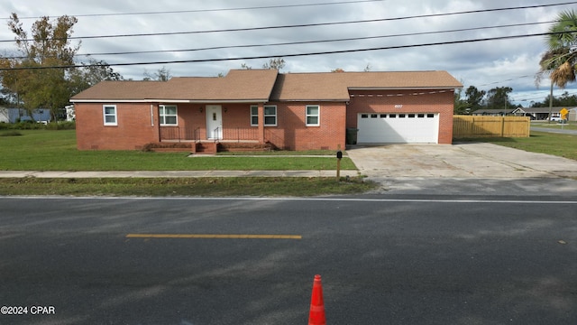 view of front facade with a front yard and a garage