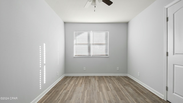 spare room with hardwood / wood-style floors and ceiling fan