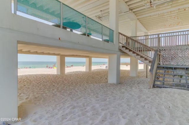 interior space featuring a water view and a view of the beach