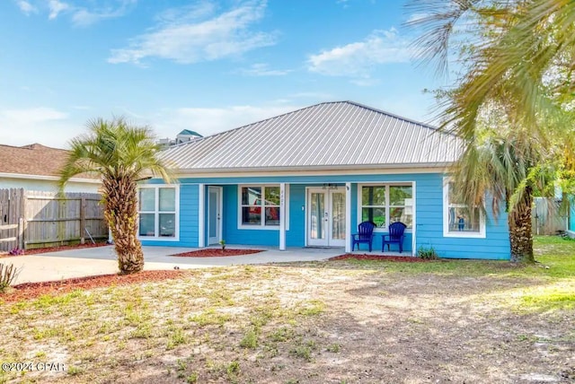 rear view of property with a yard and french doors