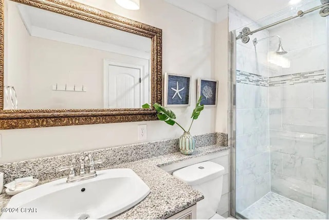 bathroom with vanity, toilet, and a shower with door