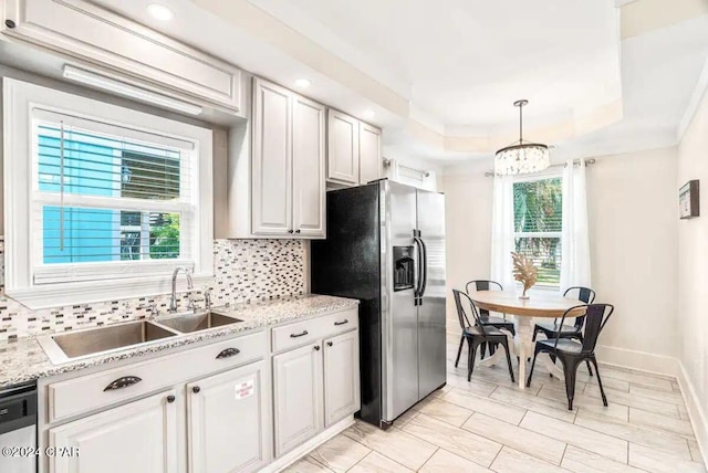 kitchen featuring sink, pendant lighting, a healthy amount of sunlight, and appliances with stainless steel finishes