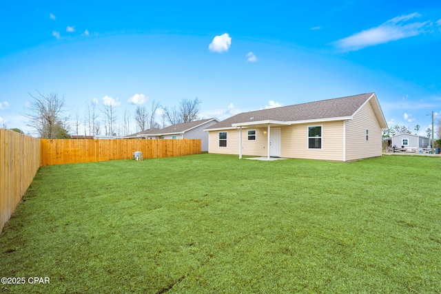 rear view of house with a lawn