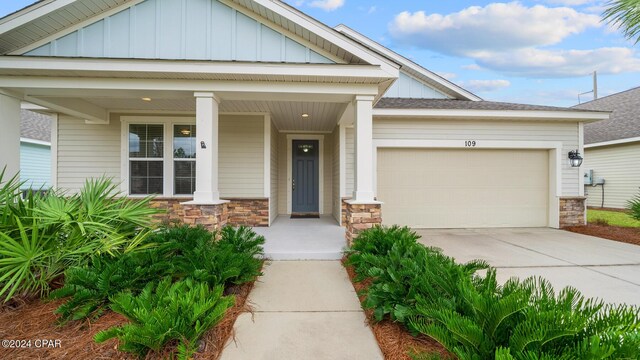 craftsman-style house featuring a porch and a garage