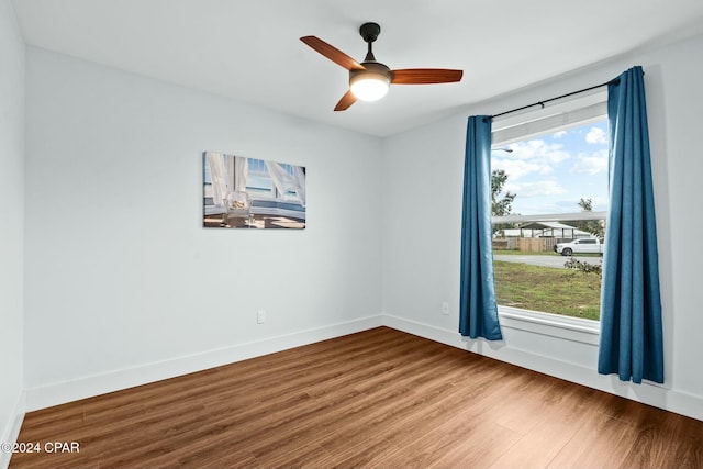 empty room featuring ceiling fan and hardwood / wood-style floors