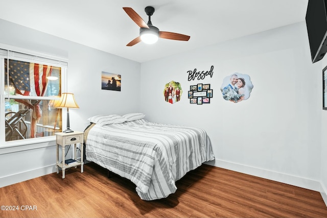 bedroom with ceiling fan and wood-type flooring