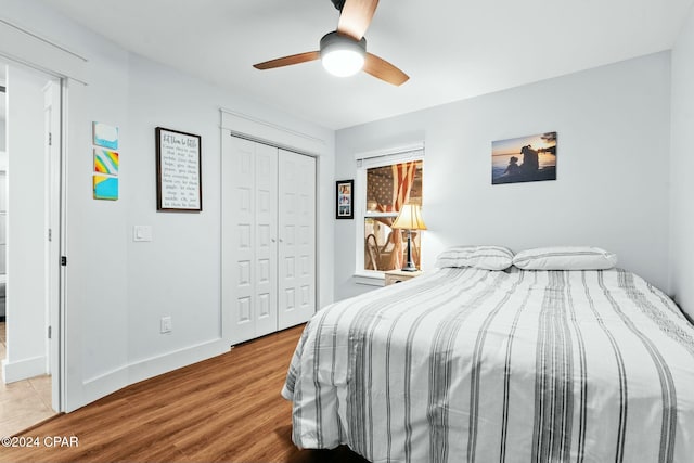 bedroom with light wood-type flooring, a closet, and ceiling fan