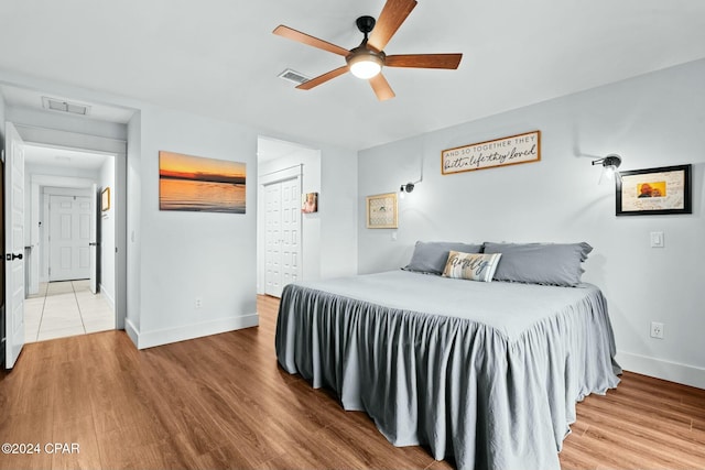 bedroom featuring ceiling fan, a closet, and hardwood / wood-style floors