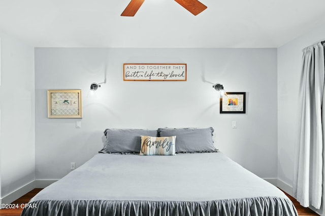 bedroom with ceiling fan and dark hardwood / wood-style floors